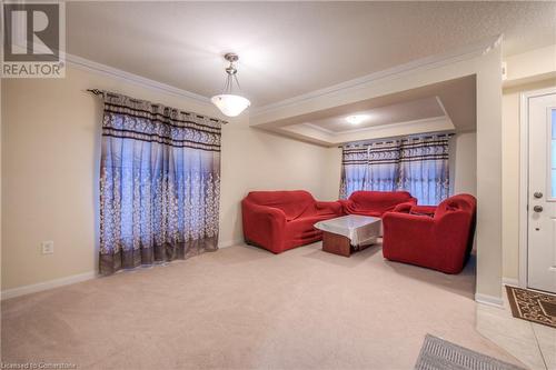 Living room featuring ornamental molding, carpet, and a tray ceiling - 66 Abbott Crescent, Cambridge, ON - Indoor