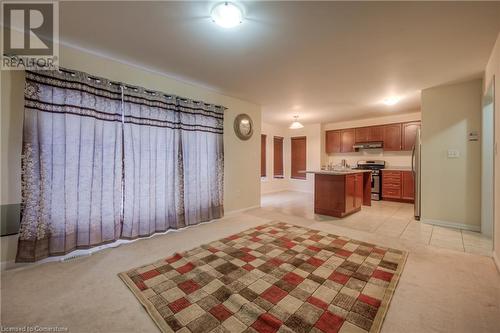 Kitchen with a kitchen island, light colored carpet, and stainless steel appliances - 66 Abbott Crescent, Cambridge, ON - Indoor Photo Showing Kitchen