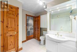 Large linen closet and custom vanity with built-in lighting. - 