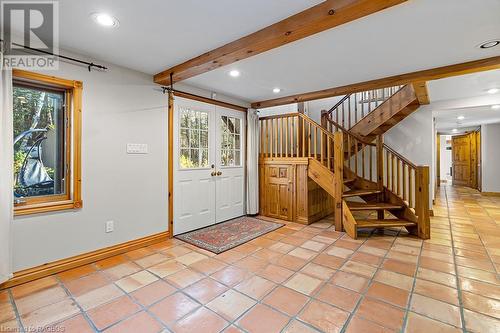 Enter the expansive foyer area with in-floor heat, timber beam ceiling and oversized closets. - 92 Moore St, Lion'S Head, ON - Indoor Photo Showing Other Room