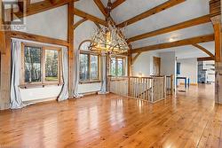 Open dining room area with custom chandelier, gleaming wood-flooring and load of natural light. - 