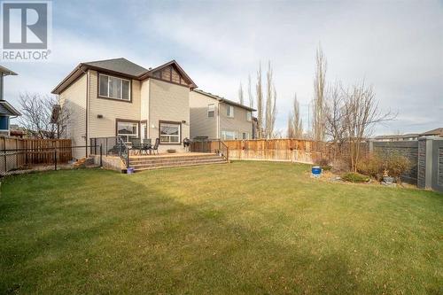 This large yard is perfect for gatherings, playtime, and relaxation, featuring a beautifully designed, expansive deck, ideal for entertaining or quiet evenings outdoors - 111 Sage Hill Green Nw, Calgary, AB 