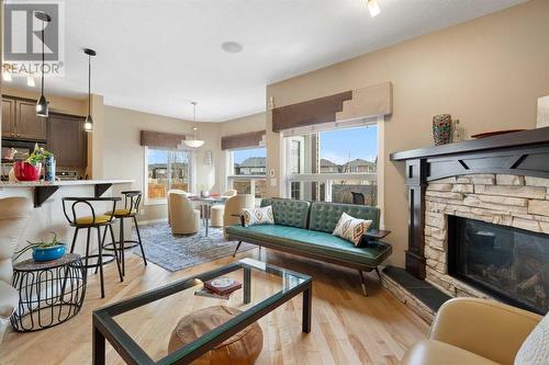 The main level offers an inviting, open floor plan with 9' ceilings and diagonally laid hardwood flooring - 111 Sage Hill Green Nw, Calgary, AB 