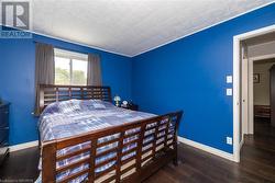 Bedroom with dark wood-type flooring - 