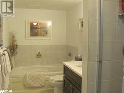 Bathroom featuring vanity, toilet, and a bathtub - 