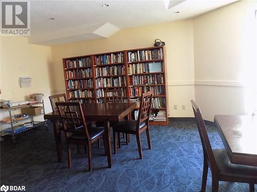 Carpeted dining room featuring a textured ceiling and vaulted ceiling - 150 E Dunlop Street E Unit# 605, Barrie, ON 