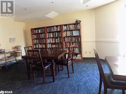 Carpeted dining room featuring a textured ceiling and vaulted ceiling - 