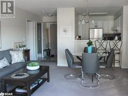 Living room featuring carpet floors and a notable chandelier - 