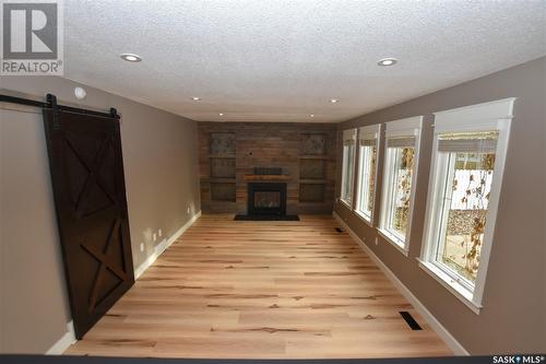 211 Victor Terrace, Dalmeny, SK - Indoor Photo Showing Other Room With Fireplace