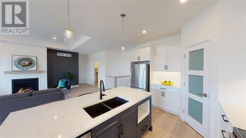 654 Ketter Way, Plympton-Wyoming, ON - Indoor Photo Showing Kitchen With Fireplace With Double Sink