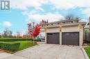 View of front of home featuring a garage and a front lawn - 2401 Coventry Way, Burlington, ON 