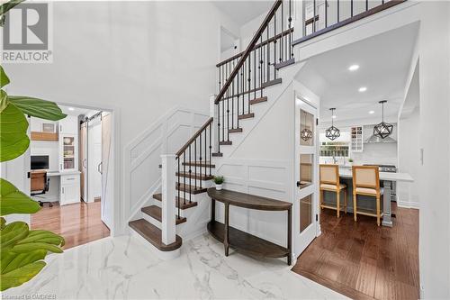 Staircase featuring built in desk, a barn door, and hardwood / wood-style flooring - 2401 Coventry Way, Burlington, ON 