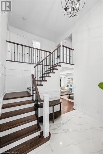 Staircase featuring an inviting chandelier - 2401 Coventry Way, Burlington, ON 