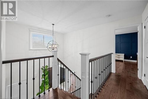 Hallway with a chandelier and dark hardwood / wood-style floors - 2401 Coventry Way, Burlington, ON 