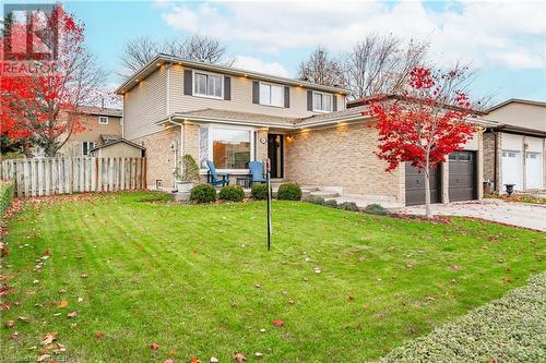 Front facade with a garage and a front yard - 2401 Coventry Way, Burlington, ON 