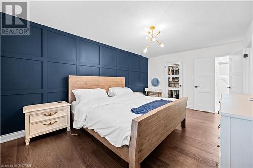 Bedroom featuring wood-type flooring and an inviting chandelier - 2401 Coventry Way, Burlington, ON 