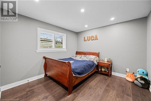 Bedroom featuring dark hardwood / wood-style flooring - 2401 Coventry Way, Burlington, ON 