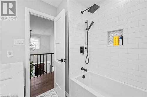 Bathroom with wood-type flooring and tiled shower / bath - 2401 Coventry Way, Burlington, ON 