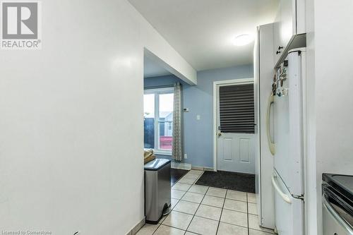 Doorway to outside with light tile patterned flooring - 48 Windom Road Unit# E, Kitchener, ON 