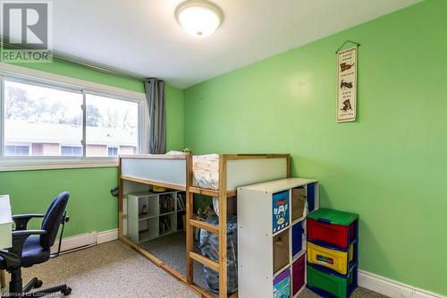 Carpeted bedroom featuring a baseboard radiator - 48 Windom Road Unit# E, Kitchener, ON 