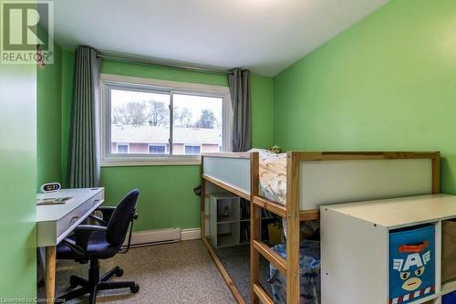 Carpeted bedroom with a baseboard radiator - 48 Windom Road Unit# E, Kitchener, ON 