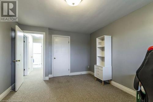 Unfurnished bedroom featuring light colored carpet - 48 Windom Road Unit# E, Kitchener, ON 