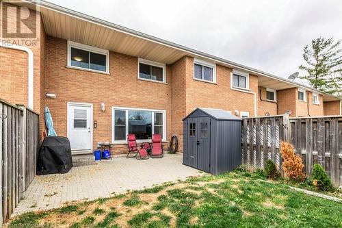 Rear view of house featuring a shed and a patio area - 48 Windom Road Unit# E, Kitchener, ON 