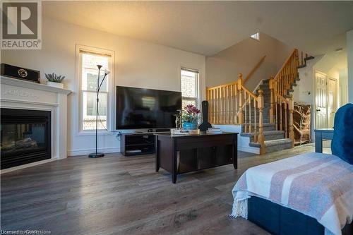 Bedroom with multiple windows and dark hardwood / wood-style flooring - 418 White Birch Avenue, Waterloo, ON 