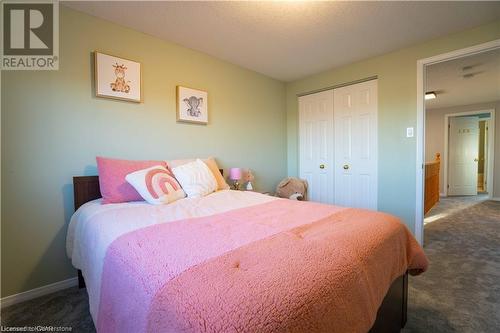 Bedroom with a closet and dark colored carpet - 418 White Birch Avenue, Waterloo, ON 