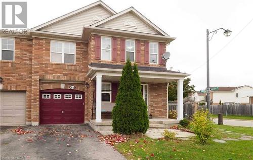 View of front of home with a garage and a porch - 89 Garth Massey Drive, Cambridge, ON - Outdoor With Facade