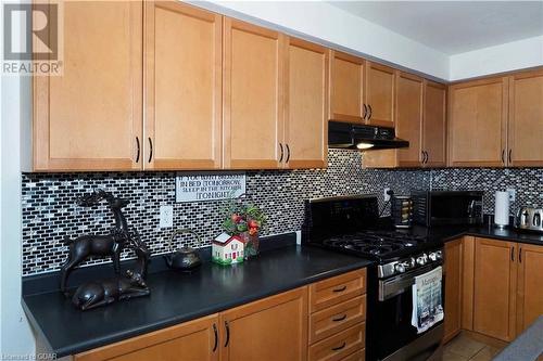 Kitchen featuring backsplash and black appliances - 89 Garth Massey Drive, Cambridge, ON - Indoor Photo Showing Kitchen