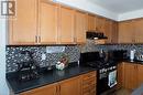 Kitchen featuring backsplash and black appliances - 89 Garth Massey Drive, Cambridge, ON  - Indoor Photo Showing Kitchen 