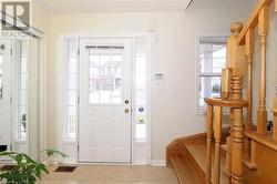 Entryway featuring a healthy amount of sunlight and light tile patterned floors - 