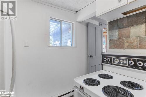 Kitchen featuring white cabinets and electric range - 72 57Th Street N, Wasaga Beach, ON 