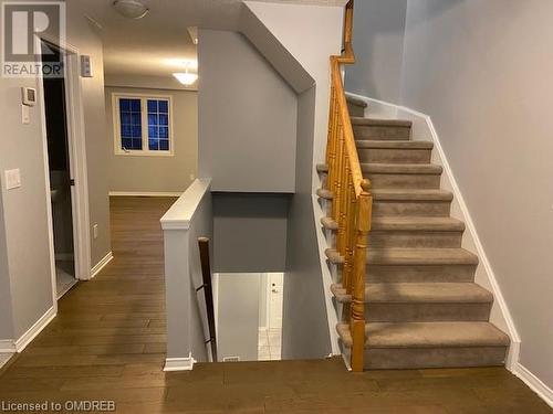 Staircase featuring hardwood / wood-style flooring and a textured ceiling - 710 Spring Gardens Road Unit# 32, Burlington, ON 