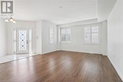 Entrance foyer featuring light hardwood / wood-style floors and a chandelier - 