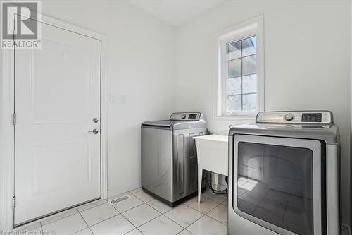 Washroom featuring separate washer and dryer and light tile patterned floors - 21 White Star Lane, Grimsby, ON 