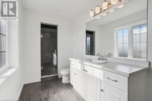 Bathroom featuring a shower with door, vanity, and toilet - 21 White Star Lane, Grimsby, ON 