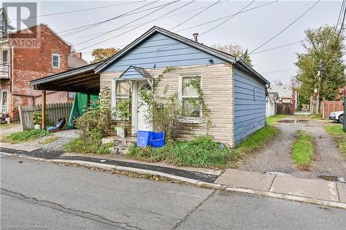 View of front of house with a carport - 97 Evans Street, Hamilton, ON 