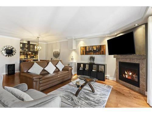 Salon - 102-651 Rue Jacques-Lavigne, Sainte-Thérèse, QC - Indoor Photo Showing Living Room With Fireplace