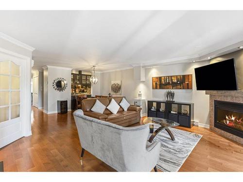 Salon - 102-651 Rue Jacques-Lavigne, Sainte-Thérèse, QC - Indoor Photo Showing Living Room With Fireplace