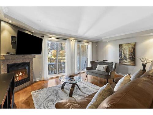 Salon - 102-651 Rue Jacques-Lavigne, Sainte-Thérèse, QC - Indoor Photo Showing Living Room With Fireplace