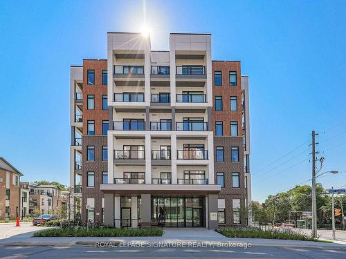 308-125 Canon Jackson Dr, Toronto, ON - Outdoor With Balcony With Facade