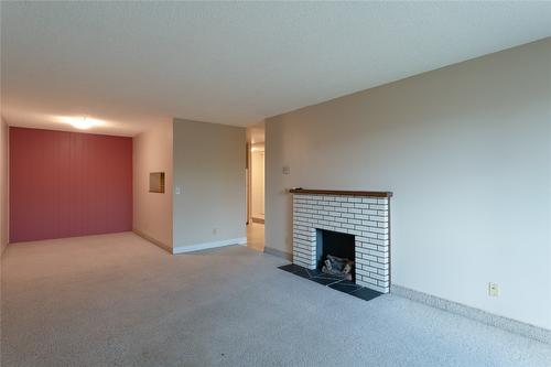 306-1915 Pacific Court, Kelowna, BC - Indoor Photo Showing Other Room With Fireplace