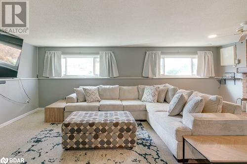 Carpeted living room with ceiling fan, a healthy amount of sunlight, and a textured ceiling - 47 Westfield Drive, St. Catharines, ON - Indoor Photo Showing Living Room