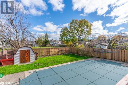 View of pool featuring a patio area, a lawn, and a shed - 47 Westfield Drive, St. Catharines, ON - Outdoor With Backyard