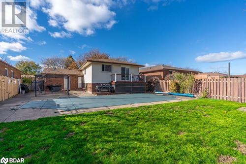 Back of property featuring a patio area, a lawn, and a covered pool - 47 Westfield Drive, St. Catharines, ON - Outdoor