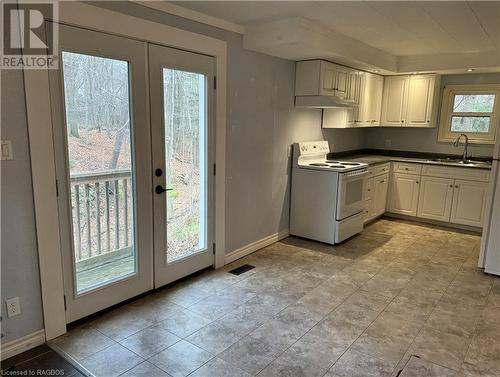 Kitchen featuring french doors to back yard - 941 20Th Street W, Georgian Bluffs, ON - Indoor Photo Showing Kitchen With Double Sink