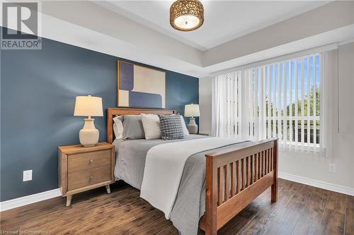 Bedroom featuring dark hardwood / wood-style floors - 2379 Central Park Drive Unit# 206, Oakville, ON - Indoor Photo Showing Bedroom