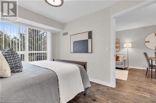 Bedroom featuring dark hardwood / wood-style flooring - 2379 Central Park Drive Unit# 206, Oakville, ON - Indoor Photo Showing Bedroom